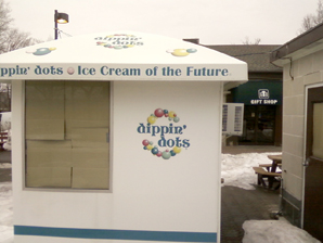 Ice Cream booth in front of Delaware North Gift Shop mere yards from brink of American Falls. Park designer Frederick Law Olmsted directed that such commerce take place in the city.